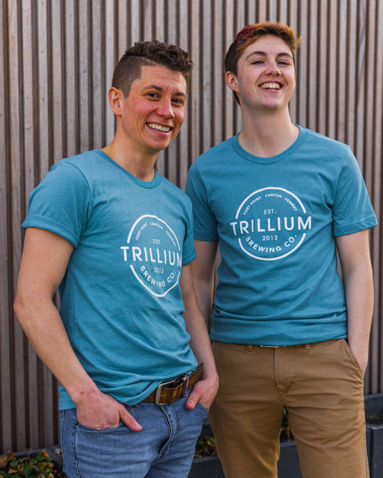Two models wearing blue lightweight tshirt with Trillium Vintage Circle Logo