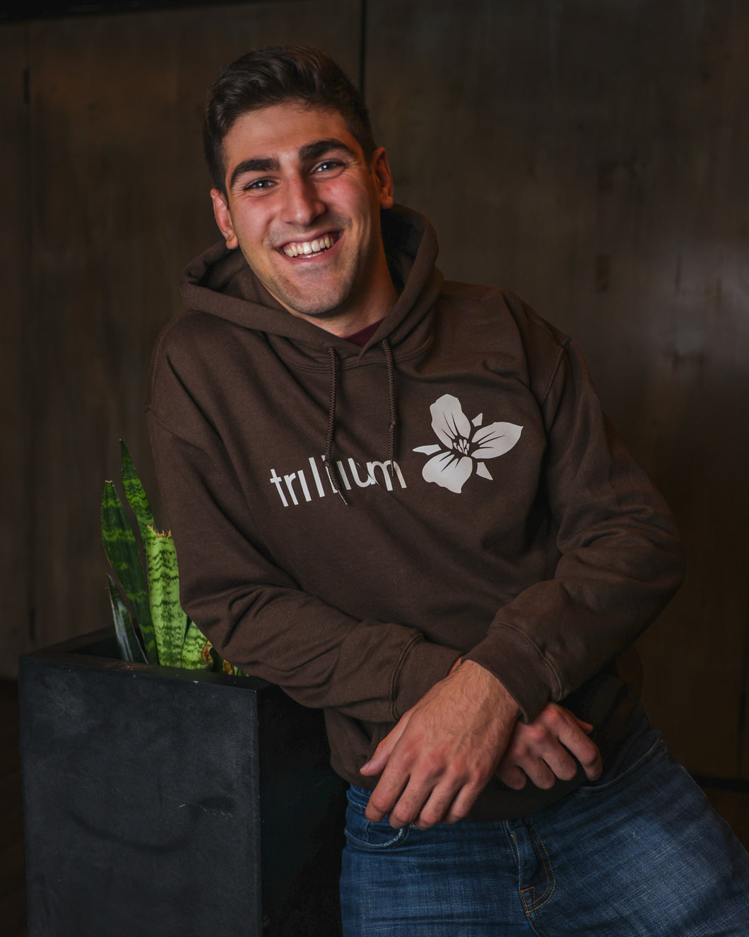 Male wearing Brown Trillium Classic Logo Sweatshirt with hoodie