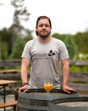 Load image into Gallery viewer, Male posing with beer in clear tulip glass wearing gray tshirt with black Trillium flower logo
