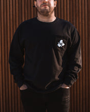 Load image into Gallery viewer, Male wearing unisex black Trillium flower logo long sleeve t-shirt
