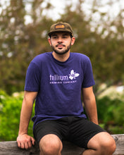 Load image into Gallery viewer, Male wearing purple Trillium Brewing T-shirt with Trillium flower logo
